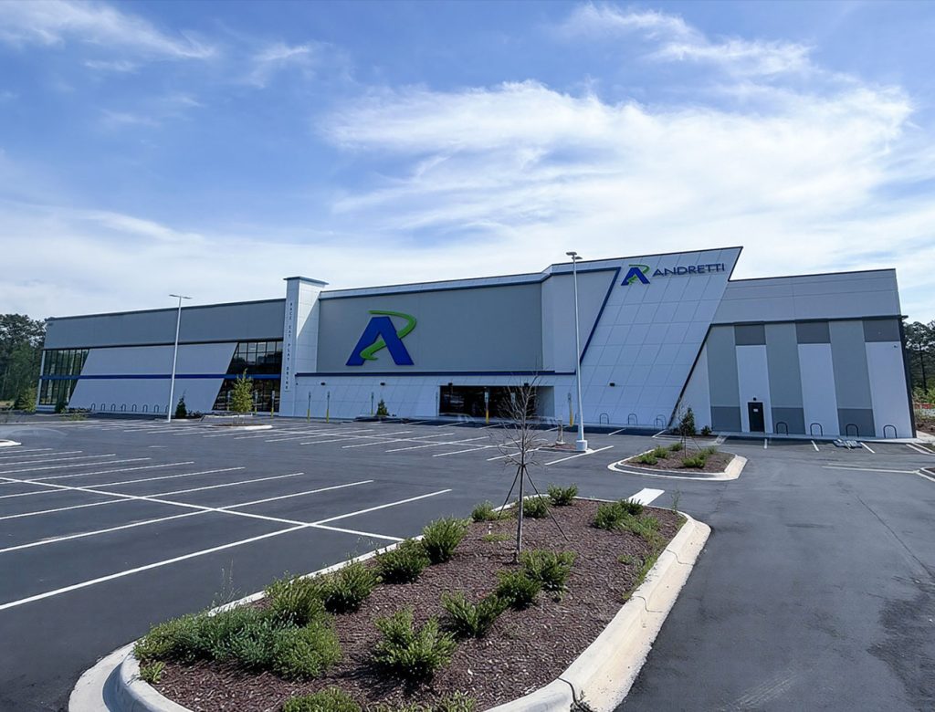 Andretti facility exterior with a large parking lot and landscaped entrance.